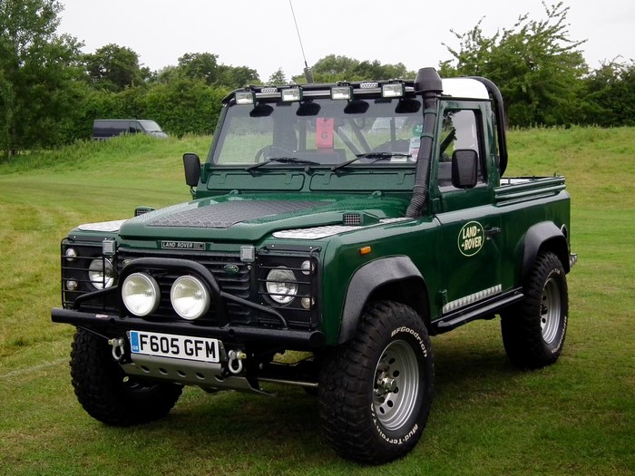 Green Land Rover Defender pickup truck