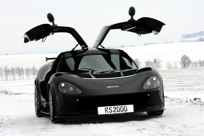 Black Melkus RS2000 sports car with doors open in snow