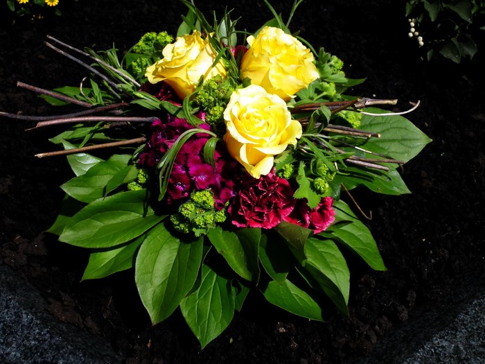Bouquet of yellow roses and purple carnations