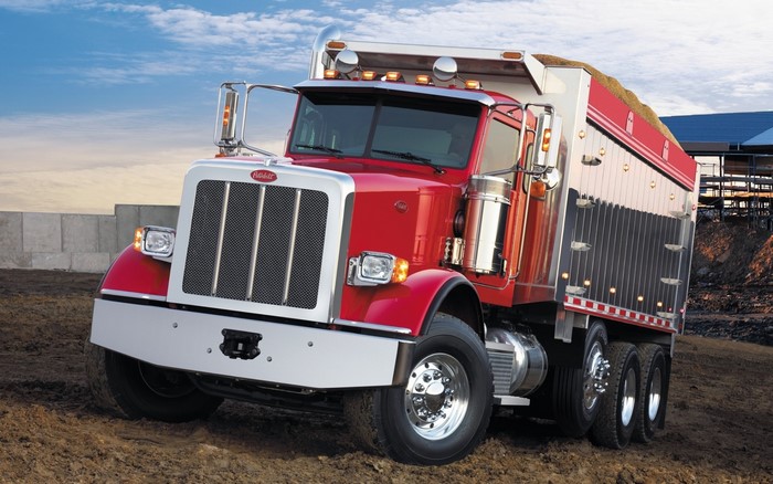 Red Peterbilt dump truck loaded with grain