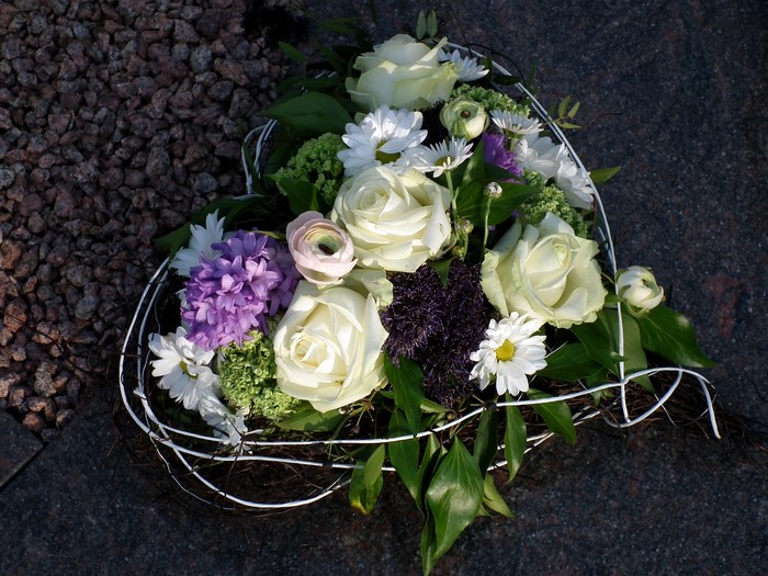 Heart-shaped floral arrangement with white roses and purple hyacinths