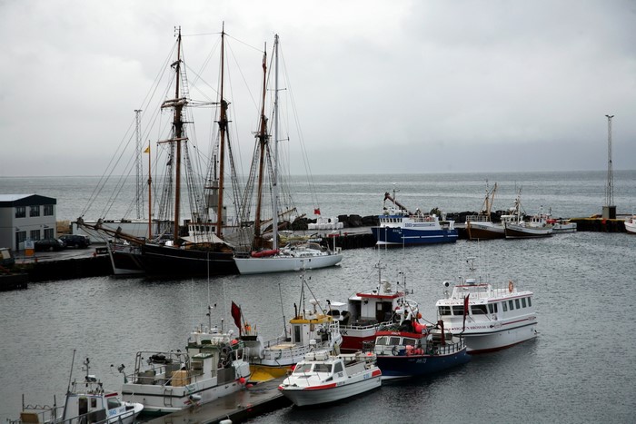 Sailing ships and boats docked in a harbor
