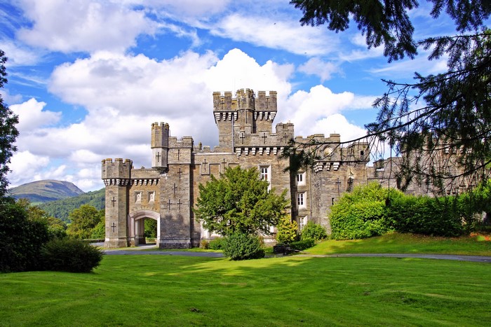 Wray Castle in Scotland with Mountains and Clouds