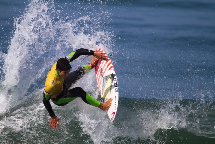 Surfer performing a trick on a wave
