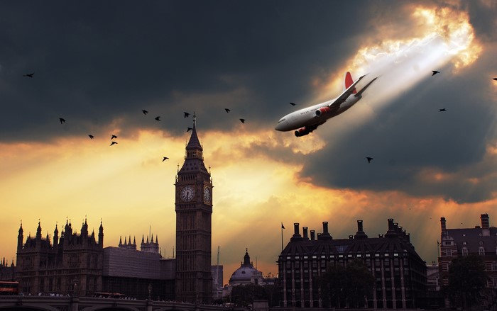 Airplane flying through stormy sky over London