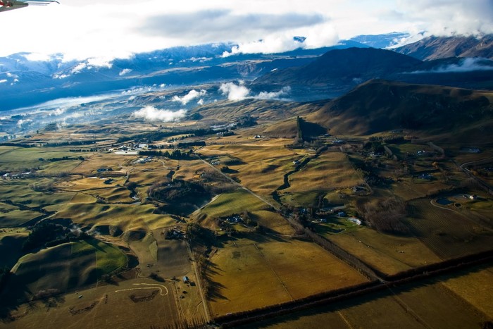 Aerial view of farmland and mountains near Queenstown, New Zealand