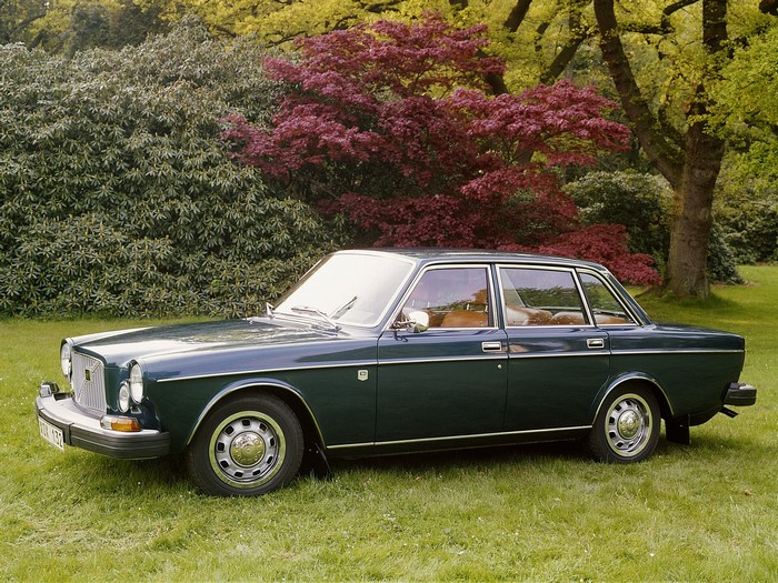 Dark green Volvo sedan parked on grass