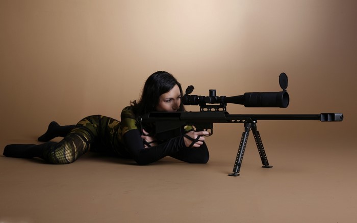 Woman aiming a sniper rifle