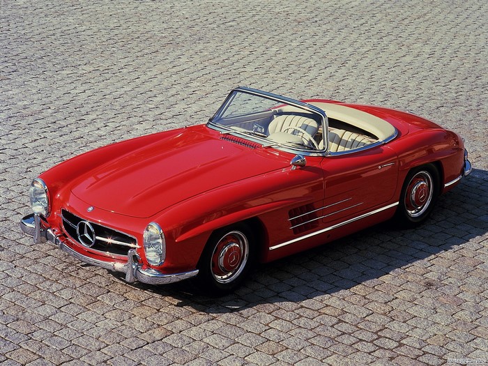 Red Mercedes-Benz 300 SL Roadster on cobblestone