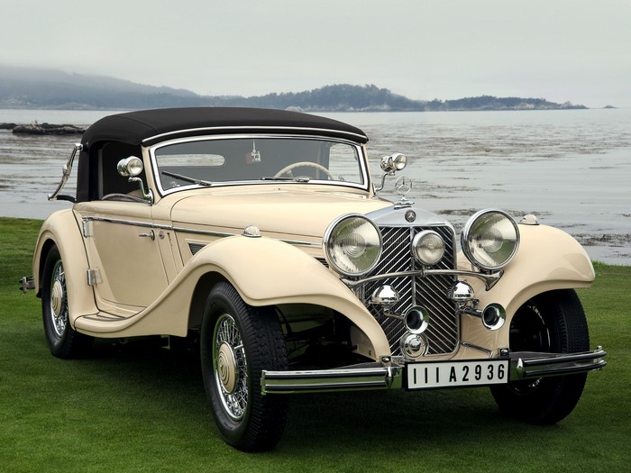 Cream Mercedes-Benz convertible parked by the ocean