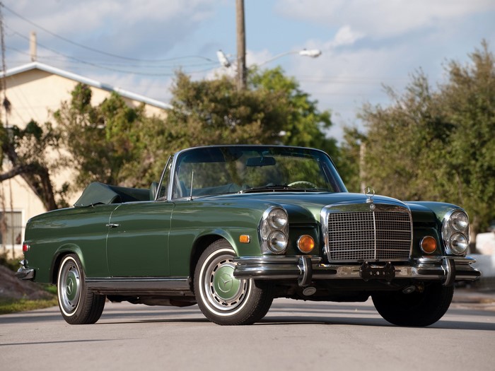 Green Mercedes-Benz convertible parked on a street