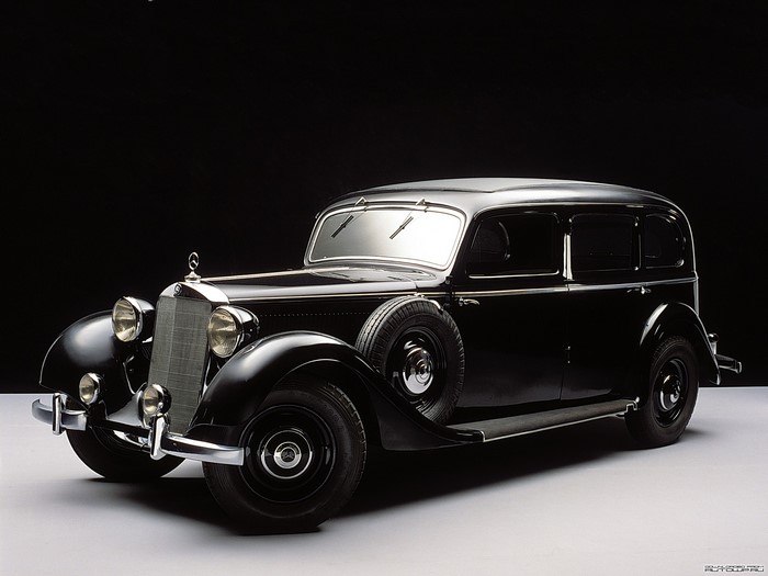 Black Mercedes-Benz sedan with spare tire