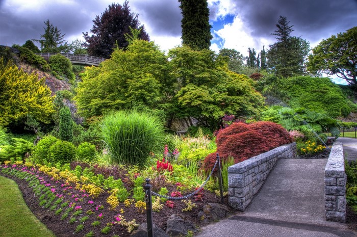 Beautiful garden with a stone bridge and colorful flowers