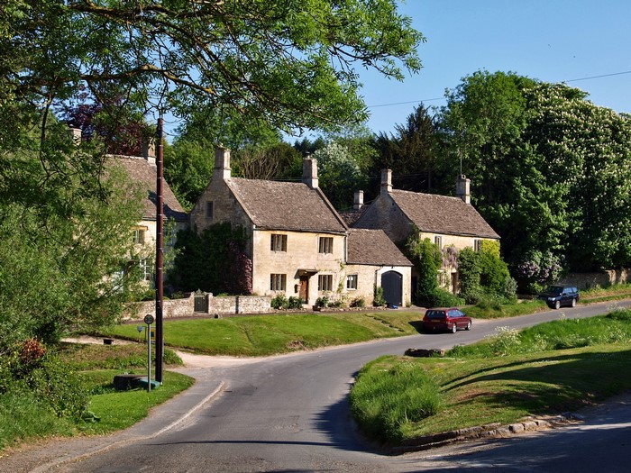 Cotswold stone cottages on a country road in the UK