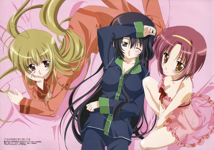 Three girls in pajamas on a pink bed