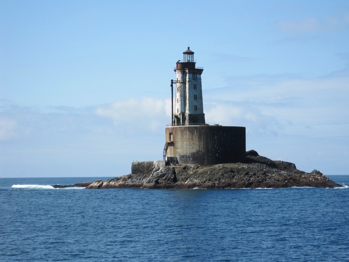 Lighthouse on a rocky island in the ocean