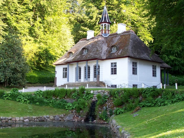 White house with thatched roof in Liselund, Denmark