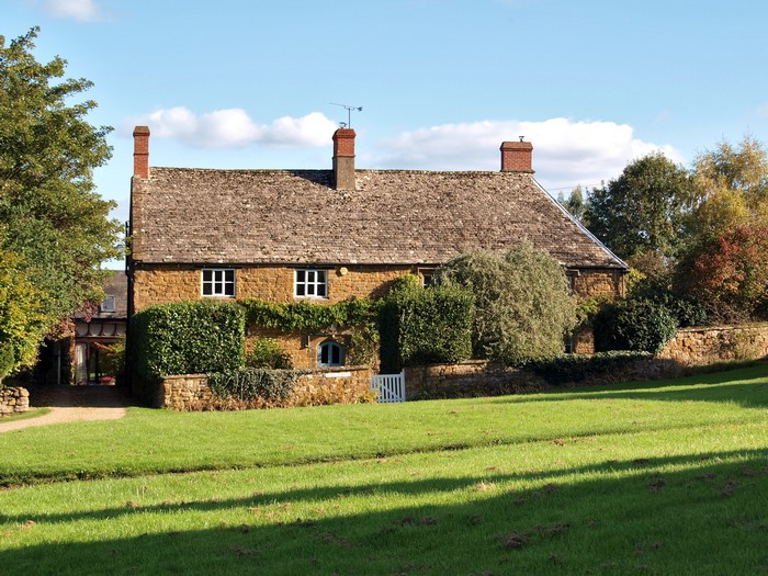 Stone cottage with thatched roof in the United Kingdom