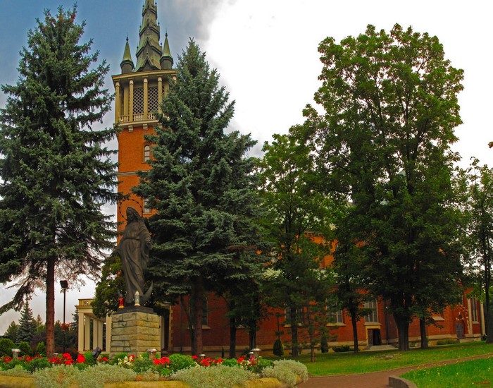 Church tower and statue in Poland