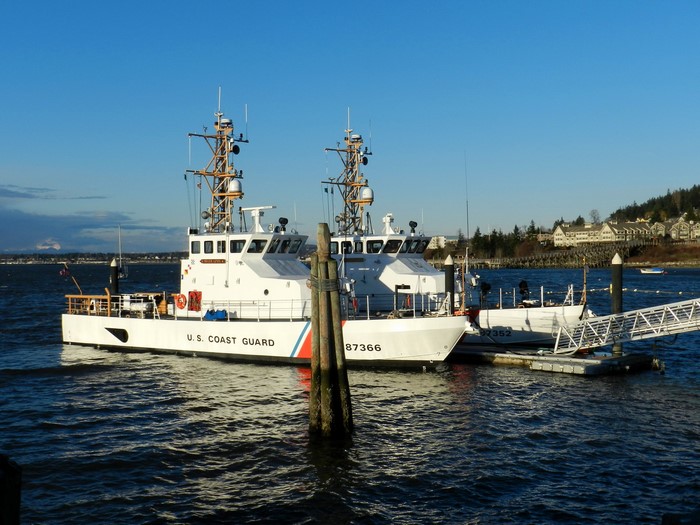 Two U.S. Coast Guard boats docked at a pier