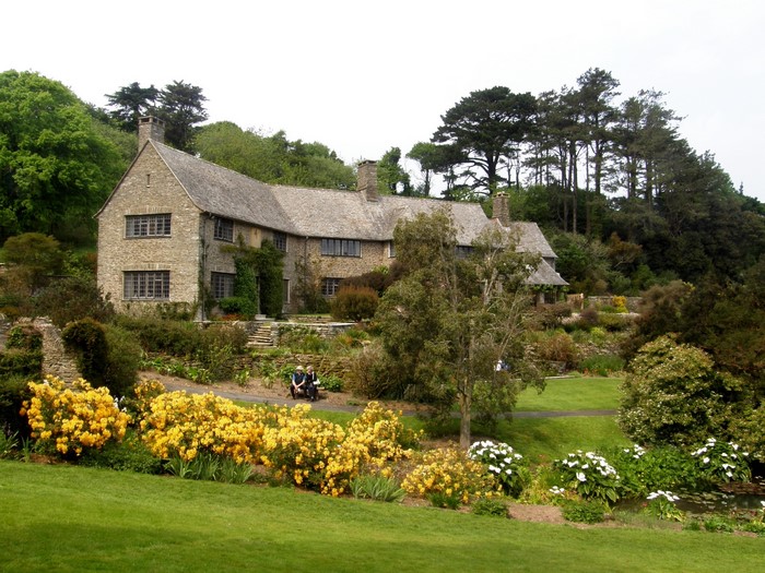 Stone house in a garden with yellow flowers