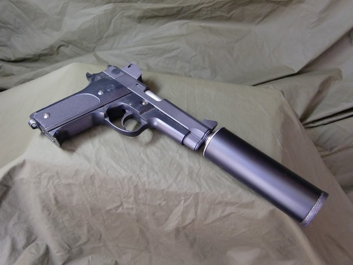 Pistol with suppressor on a cloth background