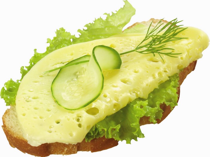 Open-faced sandwich with cheese, lettuce, cucumber, and dill