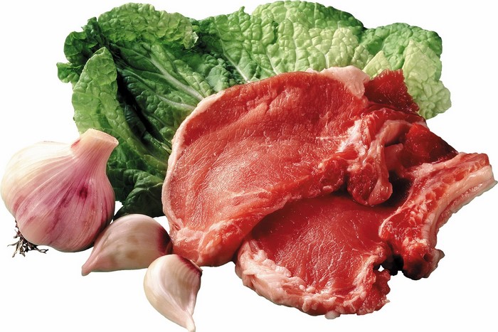 Raw pork chops with garlic and lettuce