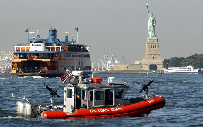 U.S. Coast Guard boat near Statue of Liberty and ferry