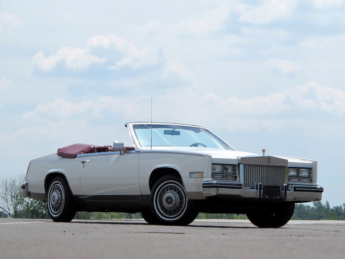 White Cadillac convertible with red interior