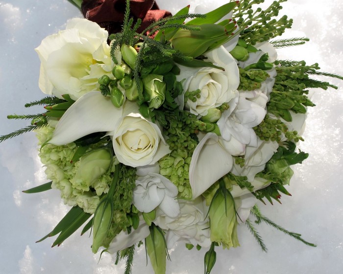 White and green floral bouquet on snow