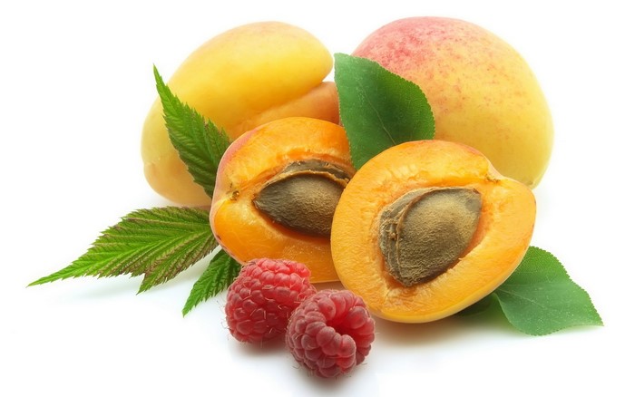 Apricots and raspberries with leaves