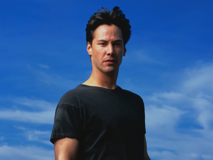 Keanu Reeves against blue sky