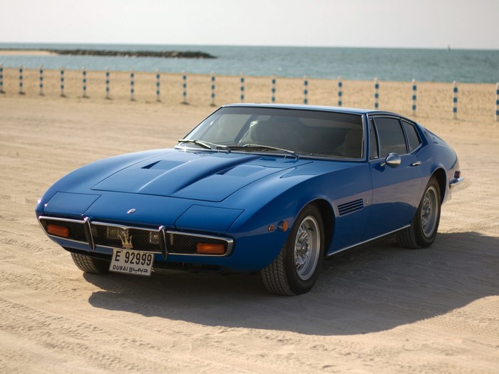 Blue Maserati car on a sandy beach