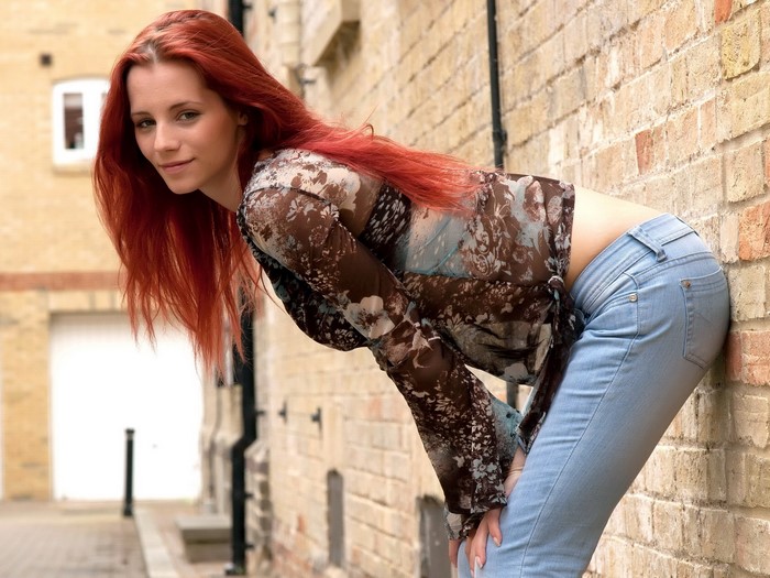 Piper Fawn leaning against a brick wall
