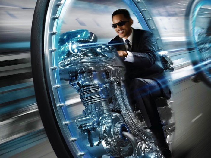 Agent J from Men in Black 3 on a futuristic motorcycle