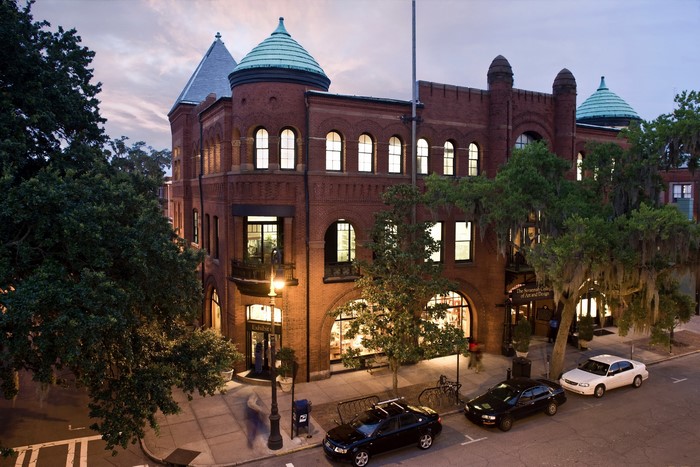 Historic brick building with domed towers at dusk