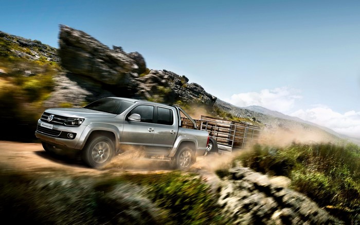 Volkswagen Amarok towing a trailer on a dirt road