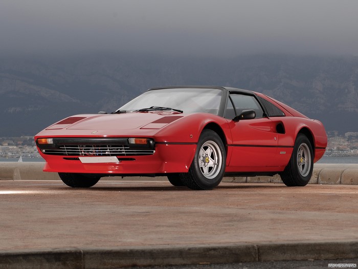 Red Ferrari 308 GTB parked by the sea