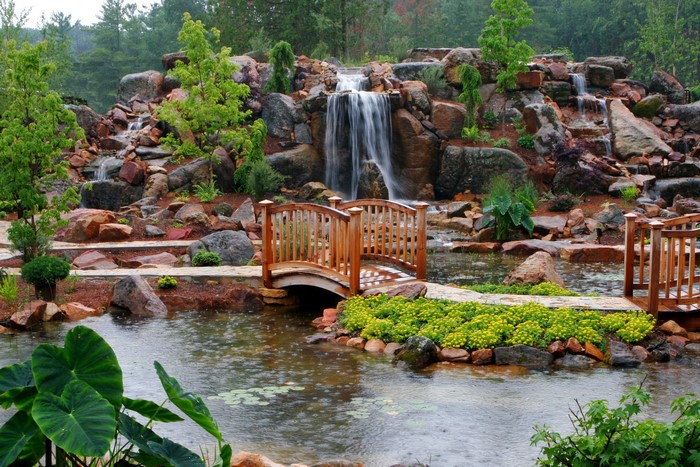 Waterfalls and a wooden bridge in a garden