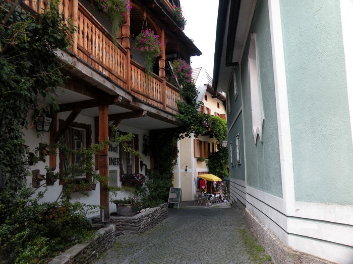 Alleyway with traditional Austrian buildings and shops in Hallstatt