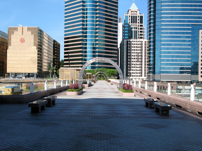 Modern cityscape with skyscrapers and a pedestrian walkway