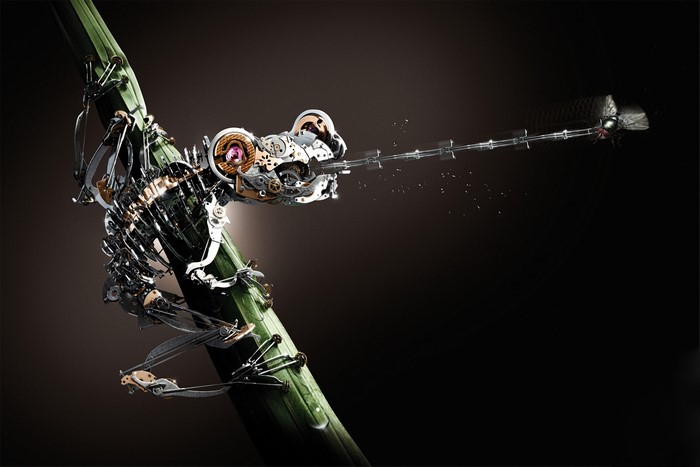 Mechanical frog catching a dragonfly on a bamboo stalk
