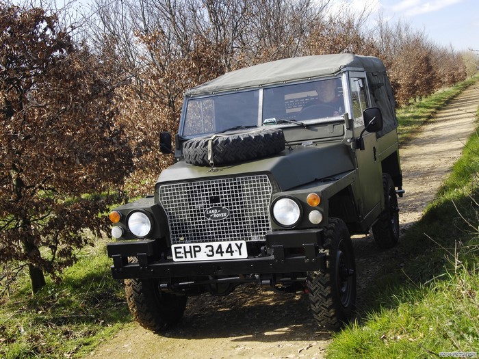 Green Land Rover Series III on a dirt road