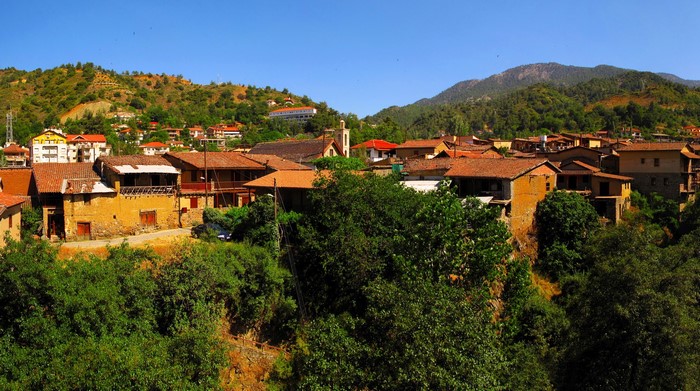 Traditional village with terracotta roofs and green hills