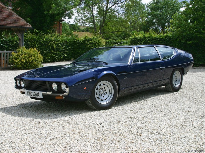 Dark Blue Lamborghini Espada parked on gravel