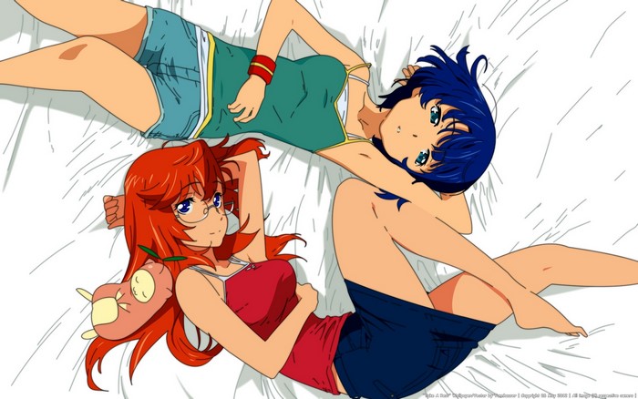 Two girls lying on a bed
