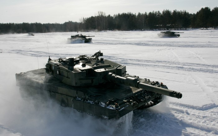 Tanks driving through a snowy landscape