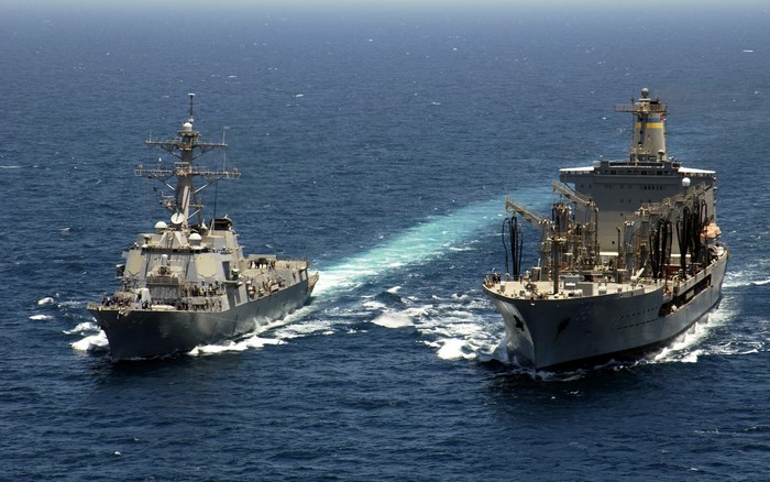 US Navy ships refueling at sea