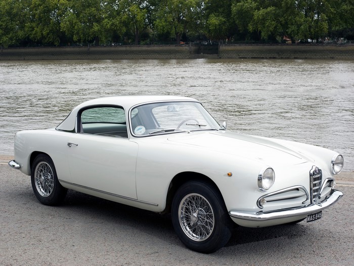 White Alfa Romeo car parked by a river